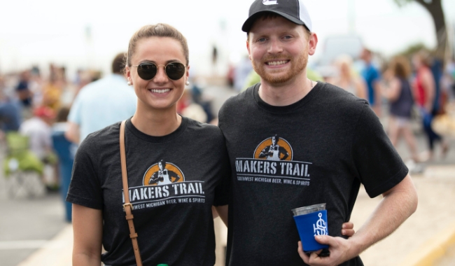 Two event attendees wearing Makers Trail shirts.